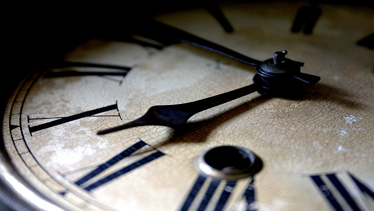 black and beige clock, closeup photo of brown and black roman numeric analog clock