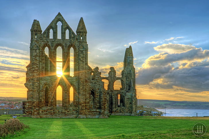 grey concrete church ruins besides body of water, Whitby Abbey