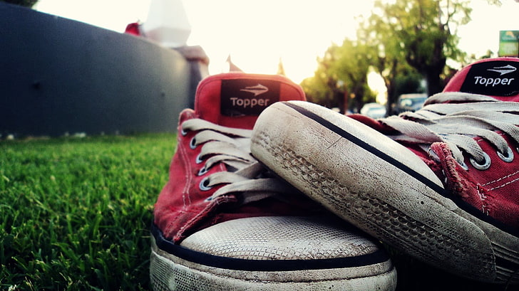 pair of red-and-white Topper low-top sneakers, shoes, grass, focus on foreground
