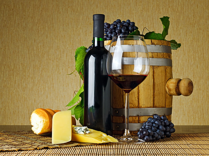 wine bottle and wine glass, leaves, table, red, cheese, bread