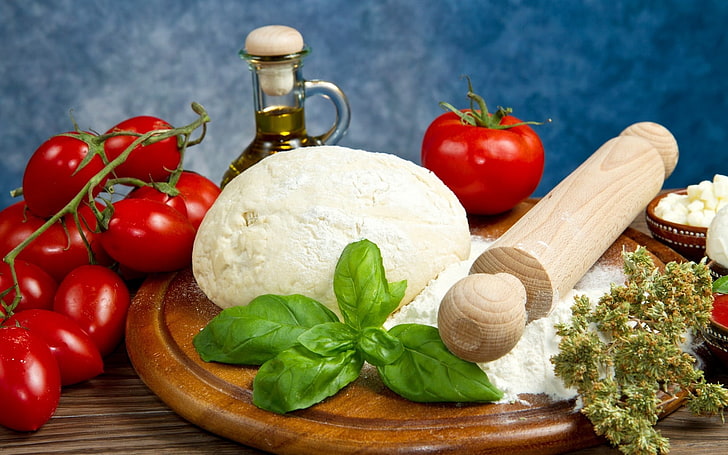 rolling pin and bunch of tomatoes, dough, flour, branch, oil