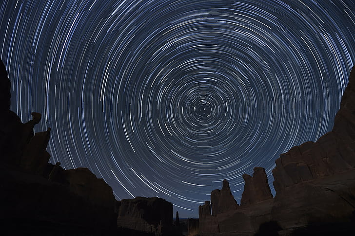 time lapse photography of brown rock formation under clear starry night during nighttime, arches national park, utah, arches national park, utah