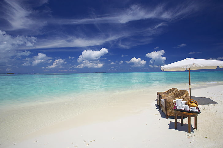 two brown wicker armchairs, maldives, ocean, beach, sand, water