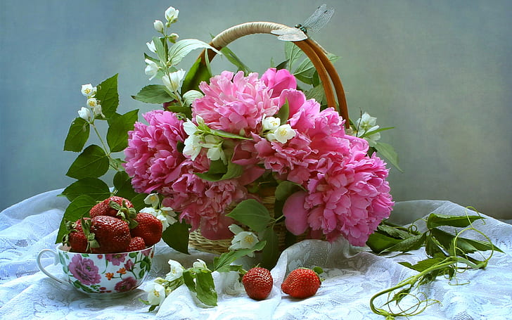 Pink peonies and white jasmine, basket, strawberry