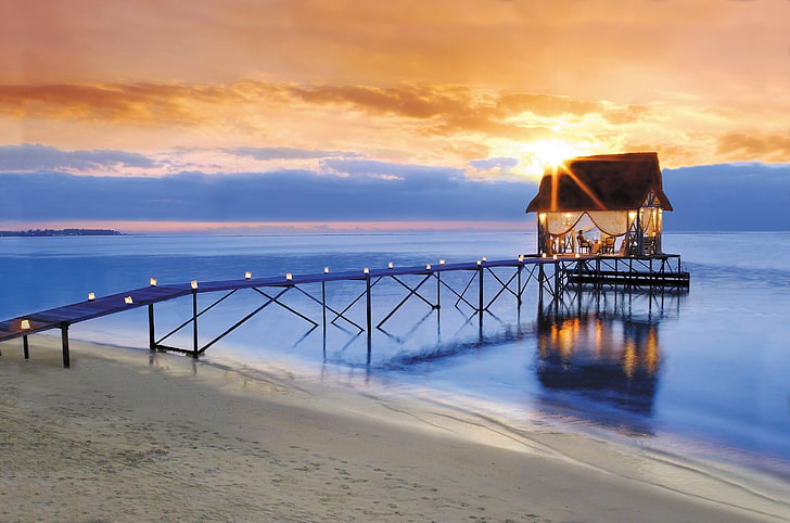brown and black dock with restaurant, beach, horizon, sea, sky