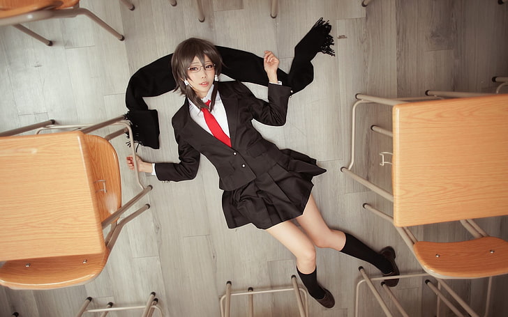 girl with black 2-button blazer and black miniskirt lying on black scarf of floor close-up photo