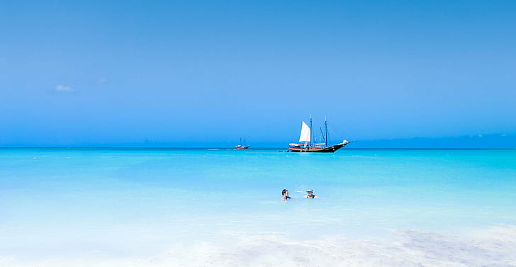 brown and white galleon boat on body of water near beach, aruba, aruba