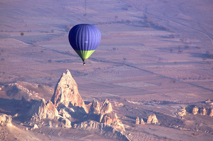 aerial photography of purple and green hot air balloon, cappadocia, cappadocia