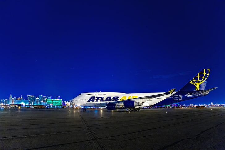 white and blue Atlas commercial airplane, night, lights, Las Vegas