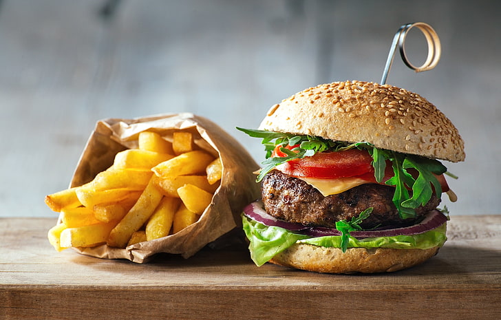 hamburger and french-fries on brown wooden board, cheeseburger