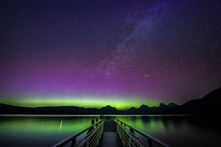 empty dock surrounded with calm body of water under purple and black sky, lake mcdonald, montana, lake mcdonald, montana