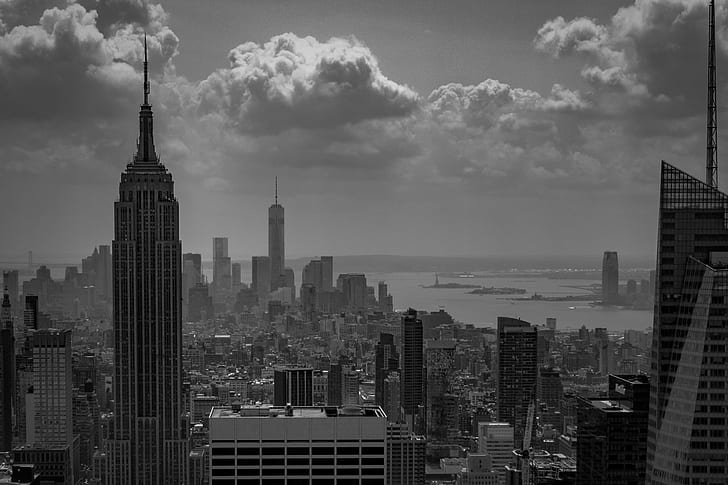 grayscale photograph of city buildings under cloudy sky, NYC