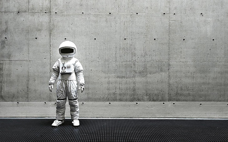 white astronaut helmet and suit, full length, one person, wall - building feature