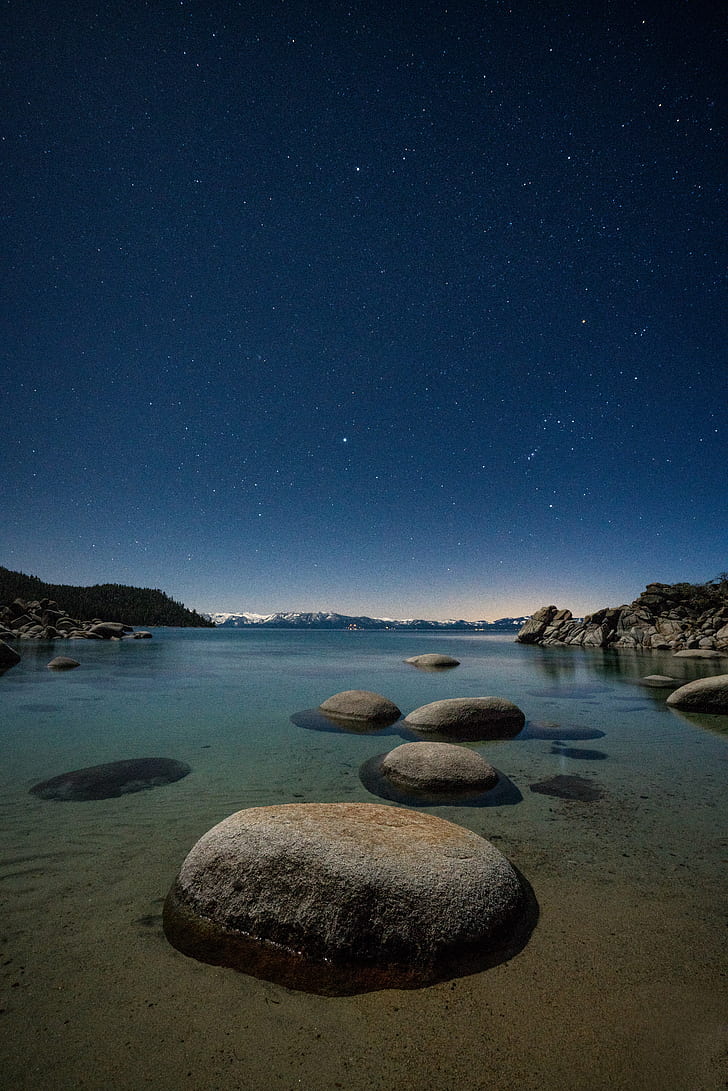 landscape photography of boulders on body of water during night time, lake tahoe, lake tahoe