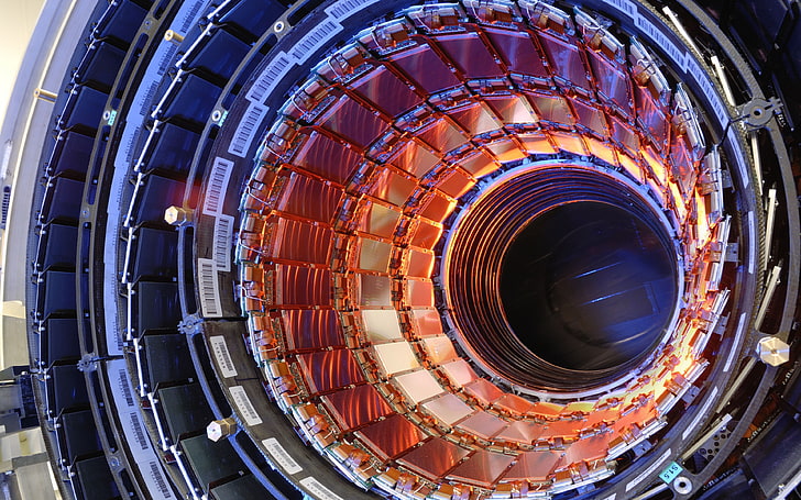 close-up photo of round gray metal case, LHC, Large Hadron Collider