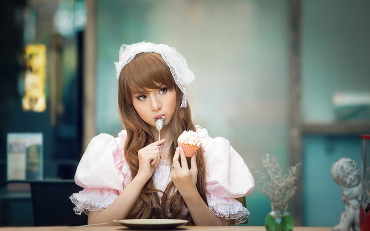 Beautiful Asian girl eating cake, lovely dress