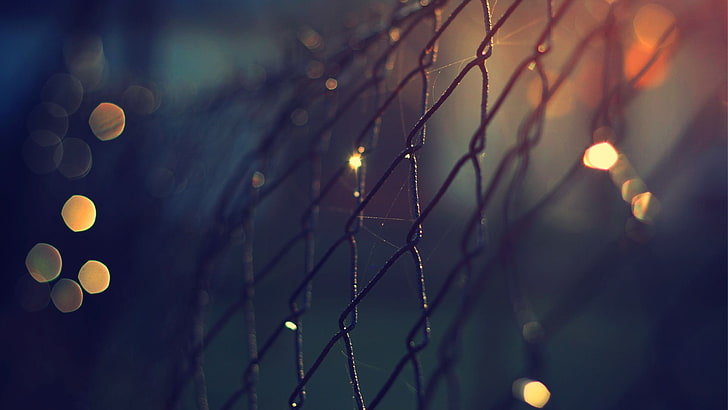 close-up photo of cyclone fence, macro shot photography of cyclone fence with light bokeh