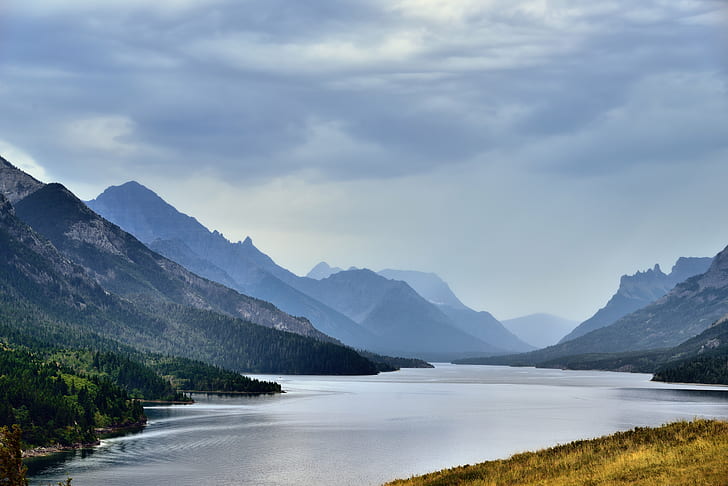 lake in the middle of green mountains during cloudy day, waterton lake, u.s., waterton lake, u.s.