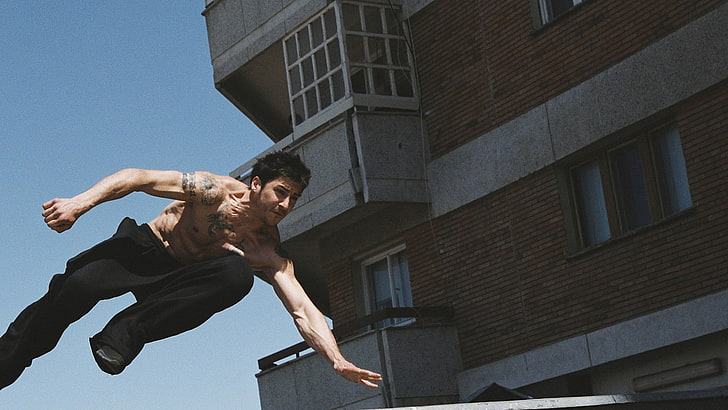 brown wooden framed glass top table, parkour, balcony, David Belle